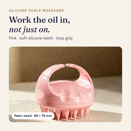 Pink silicone scalp massager with soft silicone teeth and a loop grip